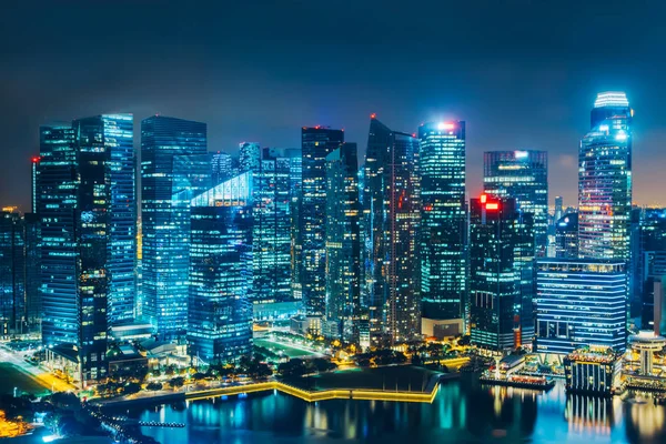 Singapore city skyline. Business district aerial view. Downtown landscape reflected in water at night in Marina Bay. Travel cityscape