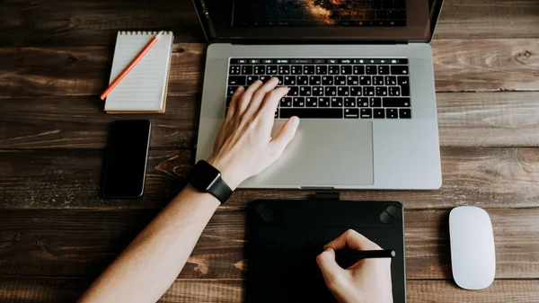 Man designer is working using laptop computer and graphics tablet at home office. Professional occupation workplace — Stock Photo, Image