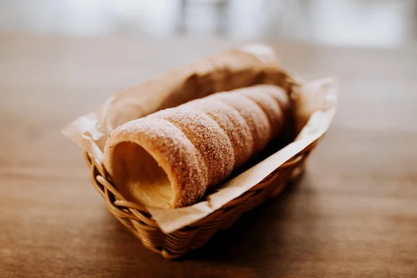 Baked trdelnik. Traditional czech food. Delicious bakery pastry food. Film look toned filter