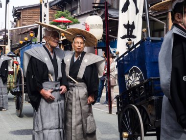 Takayama, Japonya - 10 Ekim 2015: Geleneksel kostümlü yerel halk yıllık Takayama Sonbahar Festivali geçit töreninde tarihi Takayama sokaklarında yürüyüş yapıyor