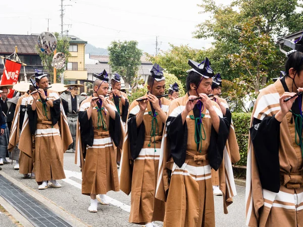 2015年10月10日 高山秋祭りのパレード中に笛を吹く伝統衣装の地元のパフォーマー — ストック写真