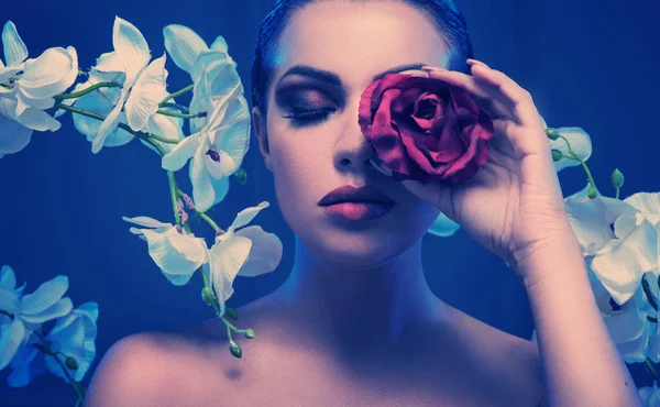 Conceptual portrait of a woman holding a rose — Stock Photo, Image