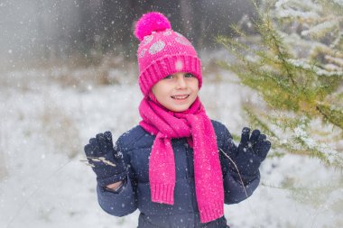 Kar yağıyor. Kız karla kaplı ormanda yürür. Kar taneleri öğreniyor.