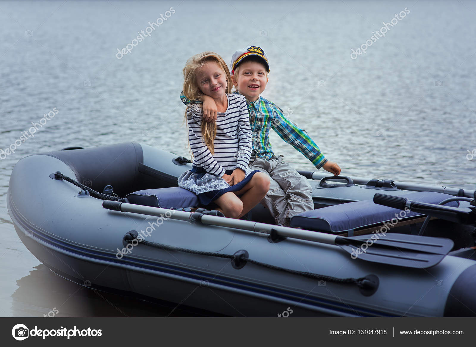Girl and boy's best friend sailing boat on the lake a summer day