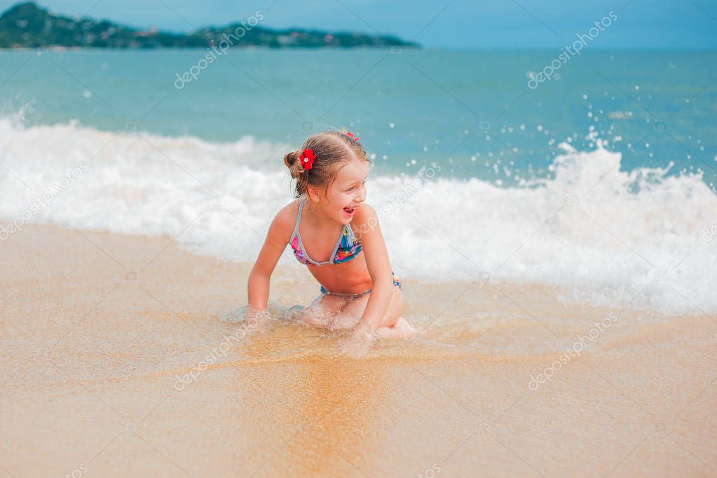 Little girl playing on beach.