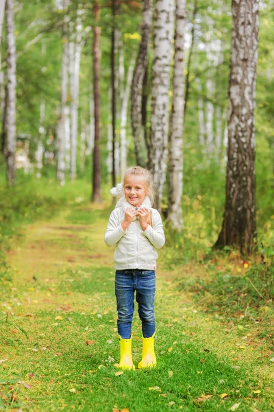 Girl with a favorite toy in the forest on a summer day. — Stock Photo, Image