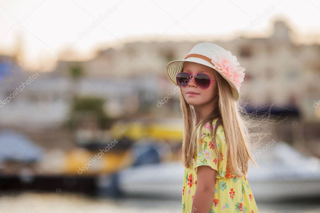Portrait of adorable little girl wearing elegant hat