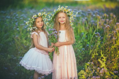 Papatya tacı takan iki güzel kızın portresi.