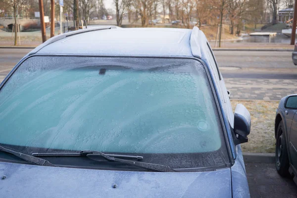 Frozen car windows, early morning on the city streets