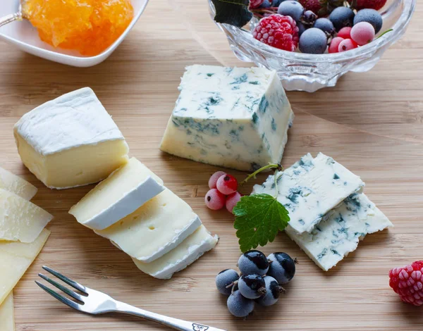 Blue cheese with frozen berries and orange jam Stock Photo