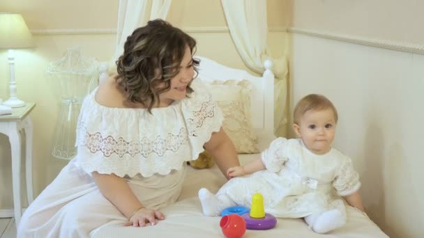 Mooie vrouw en meisje in witte jurken glimlachen en kijken naar de camera — Stockvideo