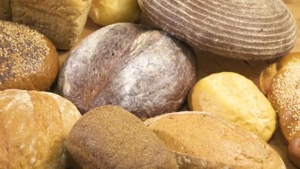 Close-up. View from above. Bread of different kinds is spinning on the table — Stock Video