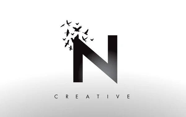 N Logo Letter with Flock of Birds Flying and Disintegrating from — Stock Vector