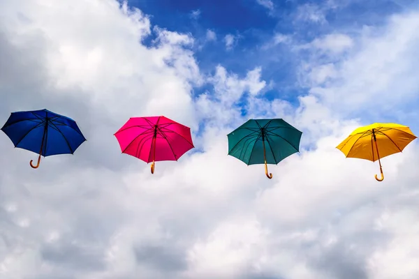 Blue Umbrella, Red Umbrella, Green Umbrella and Yellow Umbrella floating in the Air — Stock Photo, Image