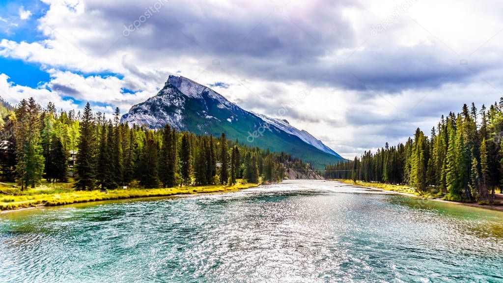 Bow River with Dark Clouds hanging over Mount Rundle in Banff National Park