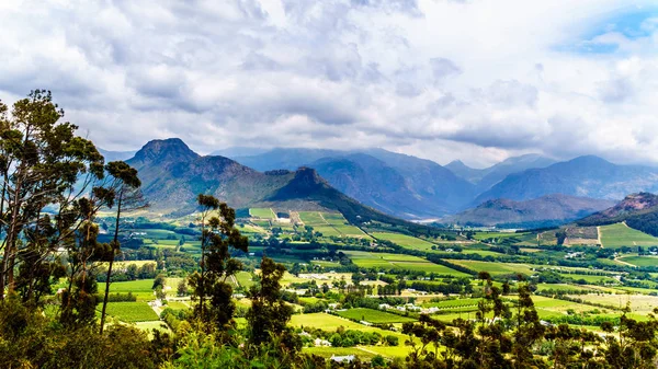 Franschhoek Valley in the Western Cape province of South Africa with its many vineyards that are part of the Cape Winelands, surrounded by the Drakenstein mountain range, as seen from Franschhoek Pass