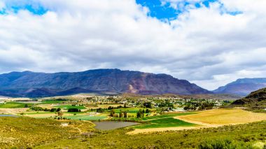 View from Highway R62 of the lovely town of Barrydale, nestled between the Tradouw Valley and the Klein Karoo, in the Western Cape Province of South Africa clipart
