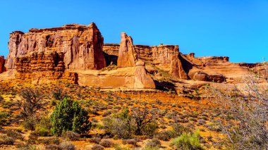 ABD 'nin Utah kentindeki Moab yakınlarındaki Arches Ulusal Parkı' nın çöl manzarasında Arches Scenic Drive boyunca uzanan uzun ve kırılgan kum taşı pinnacles.