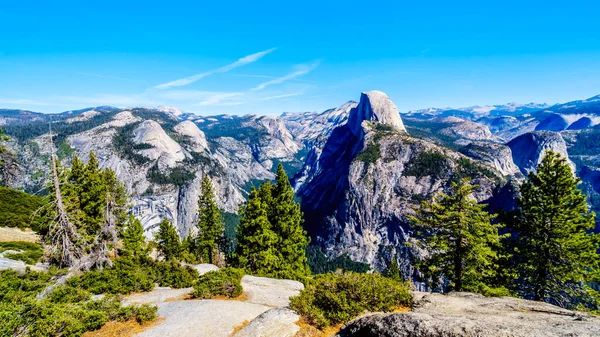 The Yosemite Valley in the Sierra Nevada Mountains with the famous Half Dome granite rock formation on the right. Viewed from Glacier Point in Yosemite National Park, California, United Sates