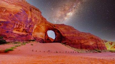 Starry Sky behind the Ear of The Wind, a hole in a rock formation in Monument Valley Navajo Tribal Park on the border of Utah and Arizona, United States clipart