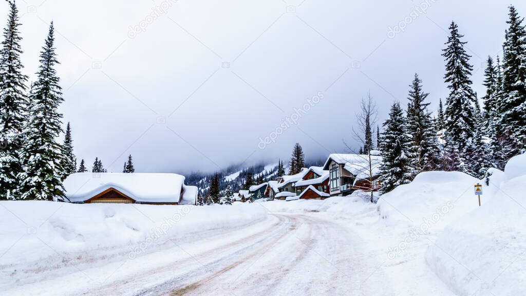 Plowed and Sanded Road in the Winter landscape at the Village of Sun Peaks, an Alpine Village in the Shuswap Highlands of British Columbia, Canada