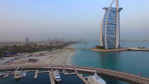 DUBAI, United Arab Emirates, August 17, 2017. Aerial. Burj Al Arab, the most famous hotel in the world. Sunrise. 4K