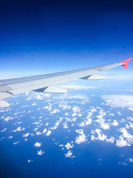 Plane flying high above the clouds — Stock Photo, Image