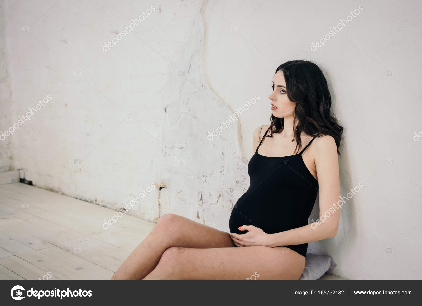 Beautiful pregnancy woman in black bodysuit — Stock Photo © Marianarbh1