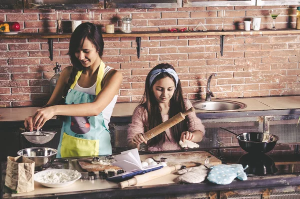 Young girls making cookies in loft style kitchen — Stock Photo, Image