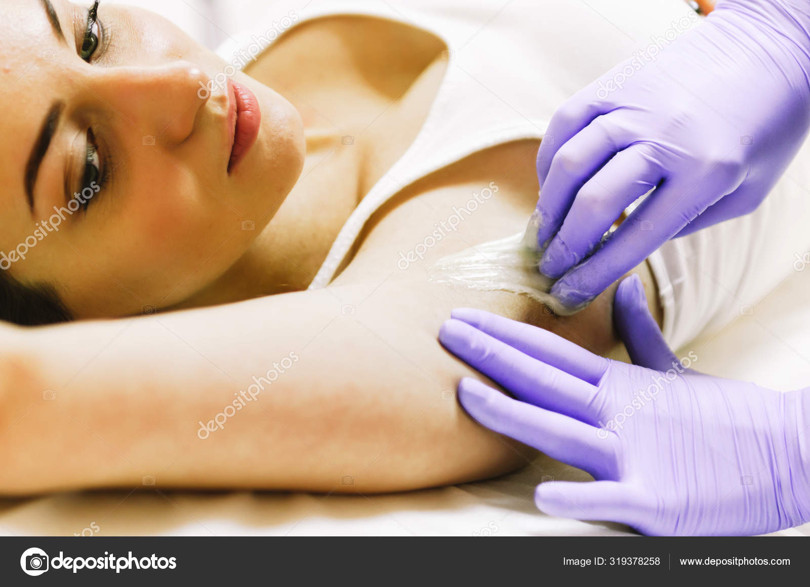 Woman doing hot sugar wax hair removal Stock Photo by ©Marianarbh1 319378258