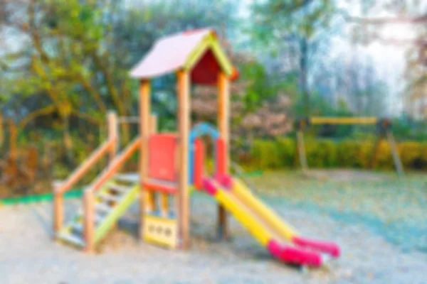 Blur colorful empty playground in nature autumn park - abstract defocused background — Stock Photo, Image