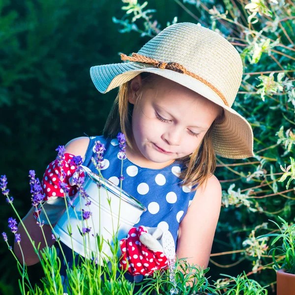 Cute girl watering herbs. Child taking care of plants. Kid with — Stock Photo, Image
