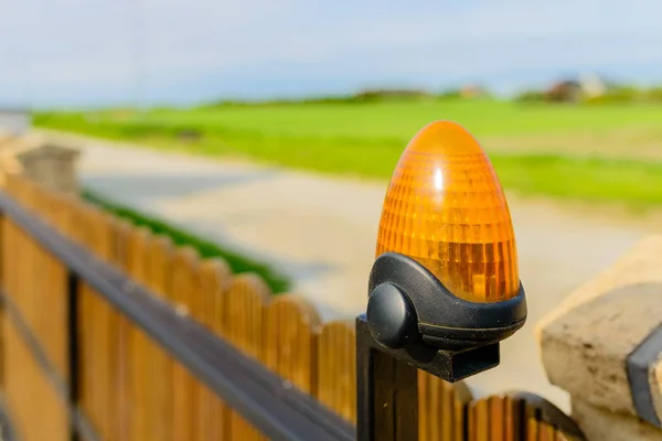 Automatic gate - wooden gate with warning lamp detail — Stock Photo, Image