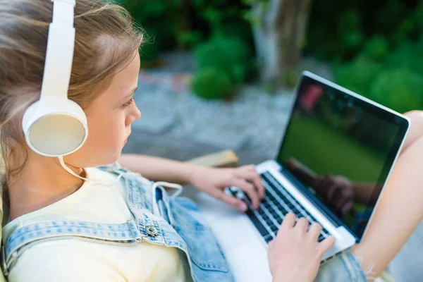 Closeup image of young girl watching video on laptop computer wi — Stock Photo, Image