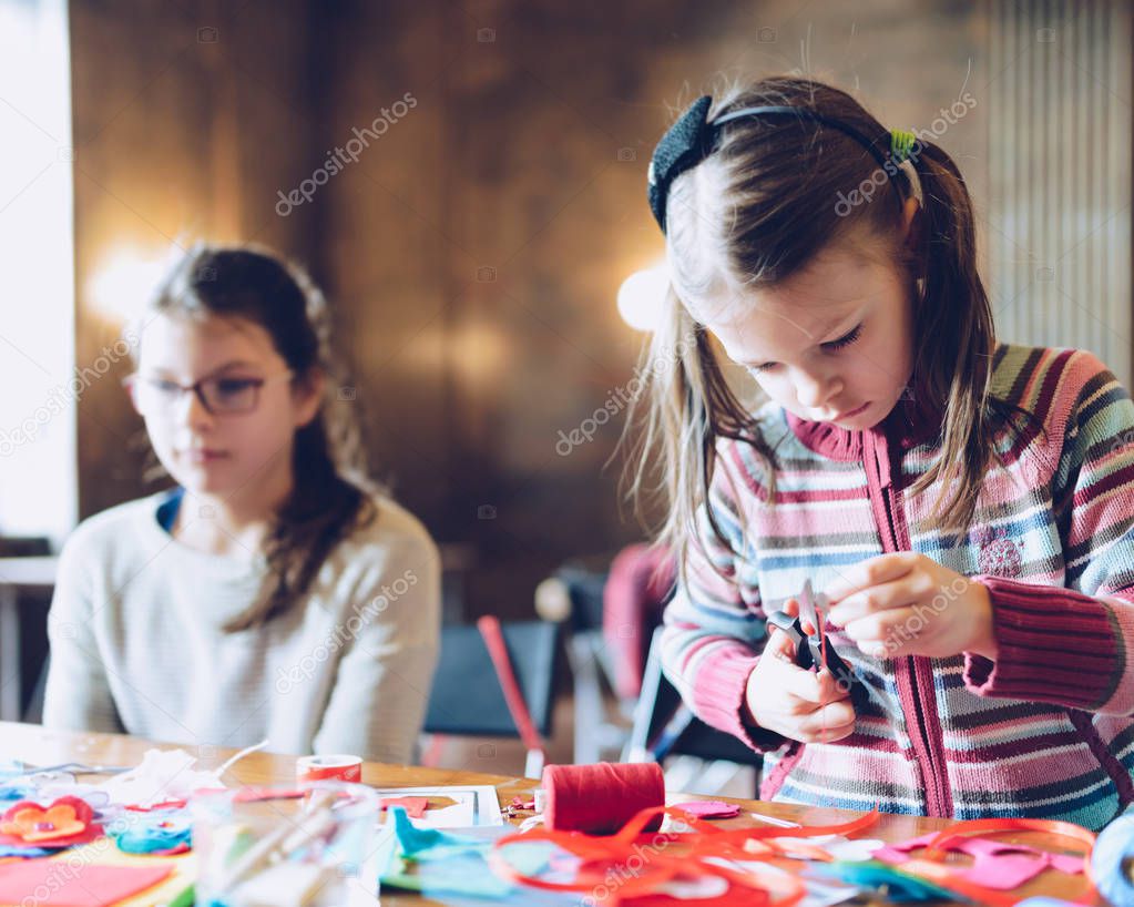 tailor art workshops for children - a girl sewing felt decorations