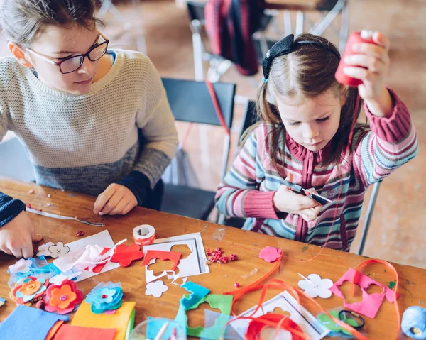 Skräddare konstverkstäder för barn - en tjej som syr kände dekorationer — Stockfoto