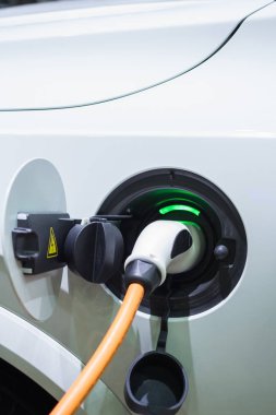 Elektrik kablosu prize takılı bir elektrikli arabayı şarj etmek...