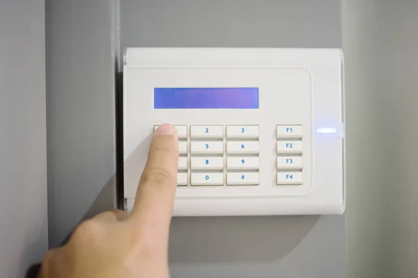 Close-up Of Person Hand entering code on keypad of home security — Stock Photo, Image