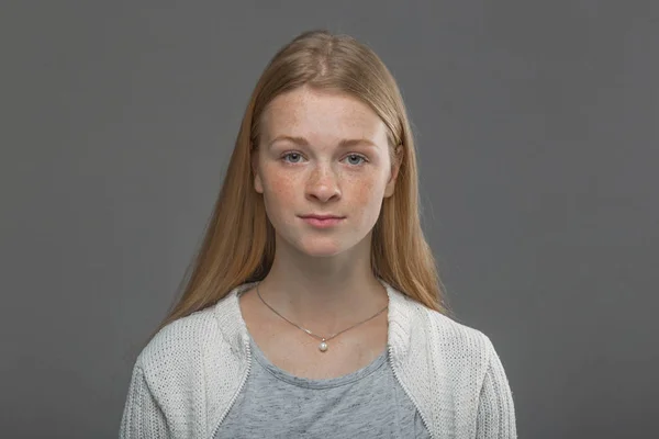 Red-haired girl close up on a gray background — Stock Photo, Image