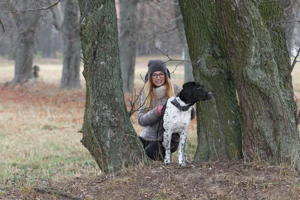 Menina com um cão para um passeio no outono — Fotografia de Stock