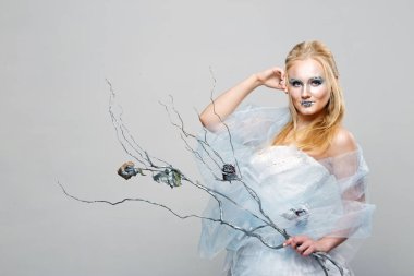 sarışın mavi makyaj ile beyaz bir elbise içinde. Kar kraliçesi.