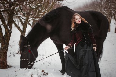 At ve kız kış ormanda