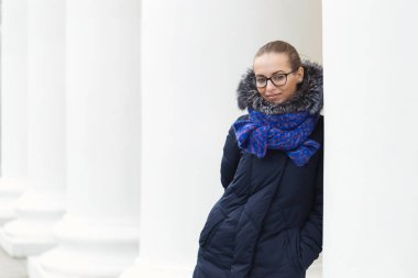 Güzel kız açık havada beyaz sütunlarla neşeli