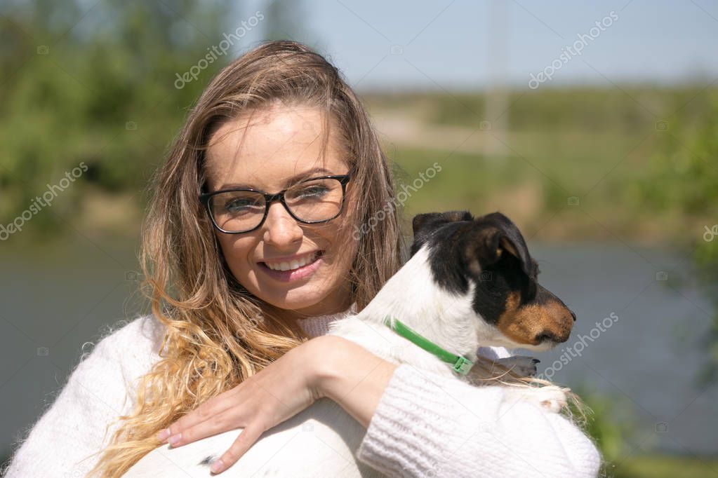 Beautiful woman playing with her dog. Outdoor portrait. series