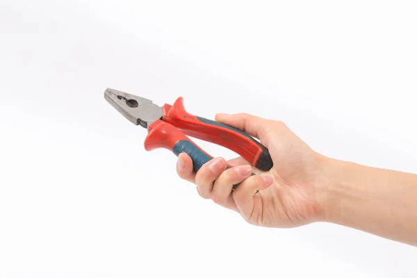 Female hands on a white background with pliers — Stock Photo, Image