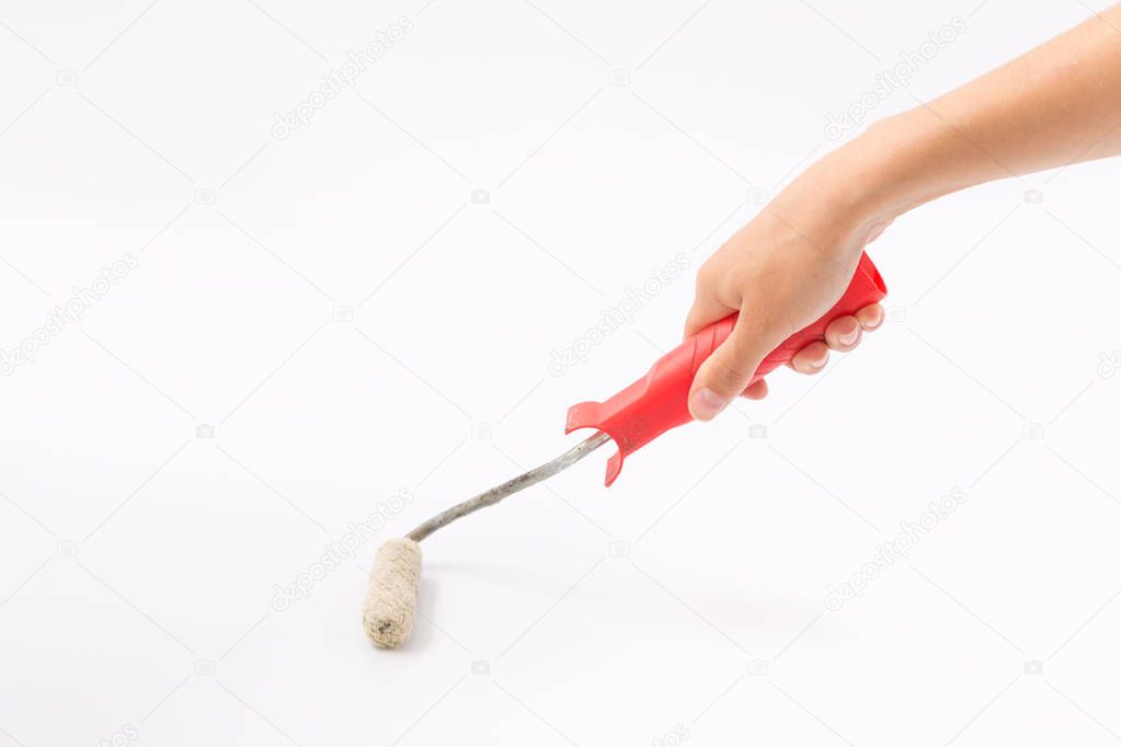 Female hands on a white background with a paint roller