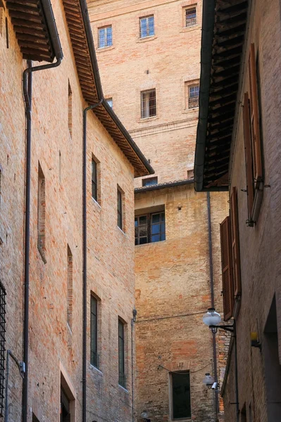 2017 년 8 월 9 일에 확인 함 . Urbino, Italy - August 9, 2017: architectural elements of a building in the old town of Urbino. 붉은 벽돌과 셔터가 달린 창문 — 스톡 사진