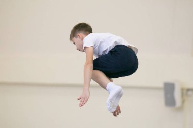 GOMEL, BELARUS - 25 November 2017: Freestyle competitions among young men and women in 2005-2007. In the program, trampoline and gymnastic path. clipart