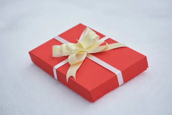 Gift in a red packing on a white background — Stock Photo, Image