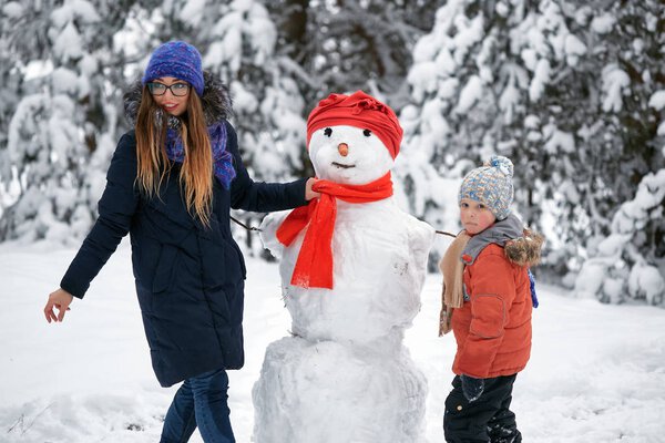 winter fun. a girl and a boy making snowballs.